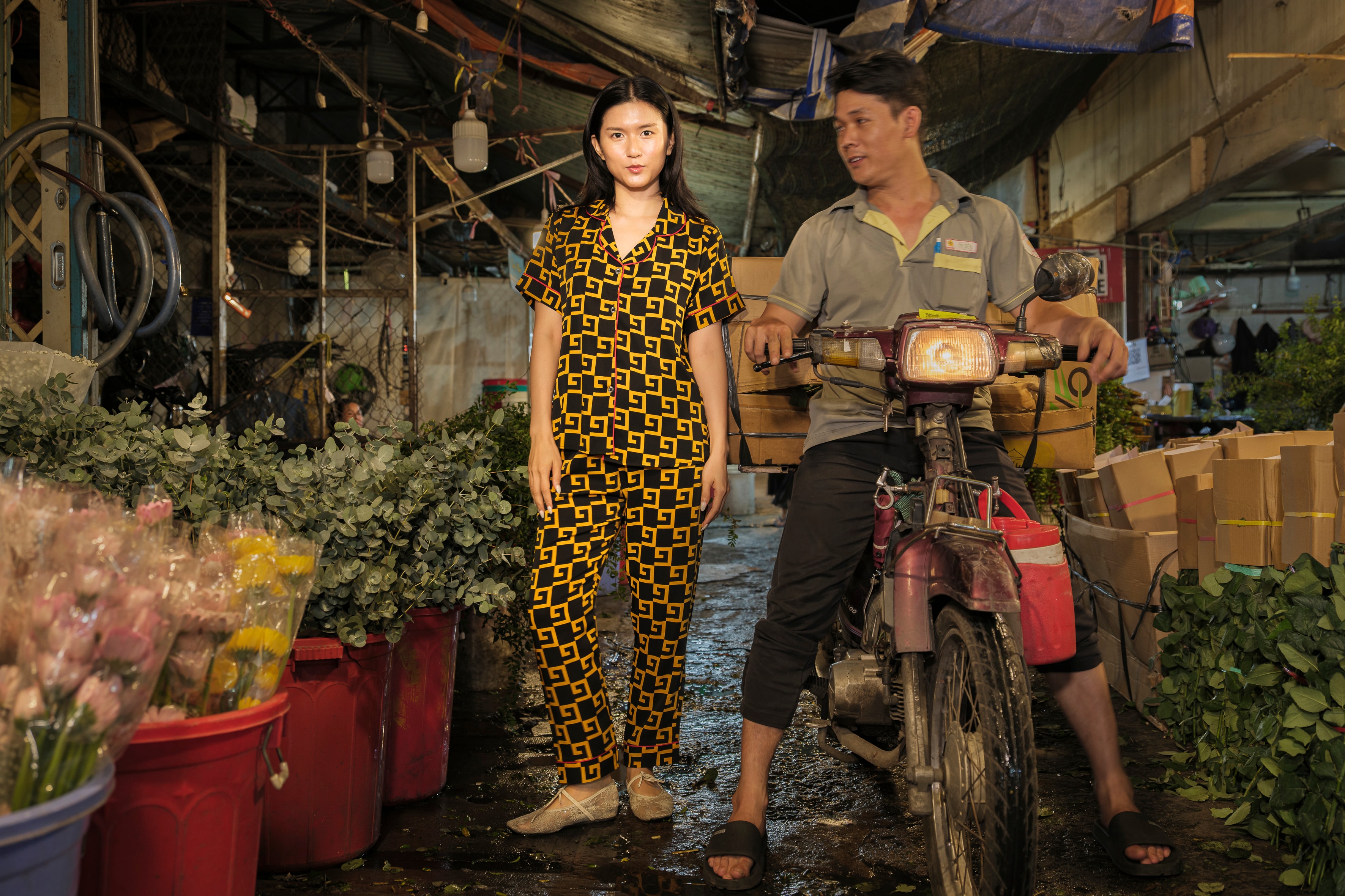 Woman and motorbike rider in flower market — The Pyjama Project, Ho Chi Minh City 2025